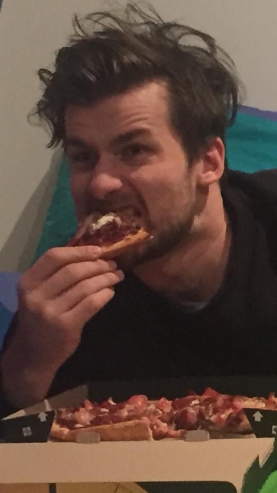 image of lewis eating pizza